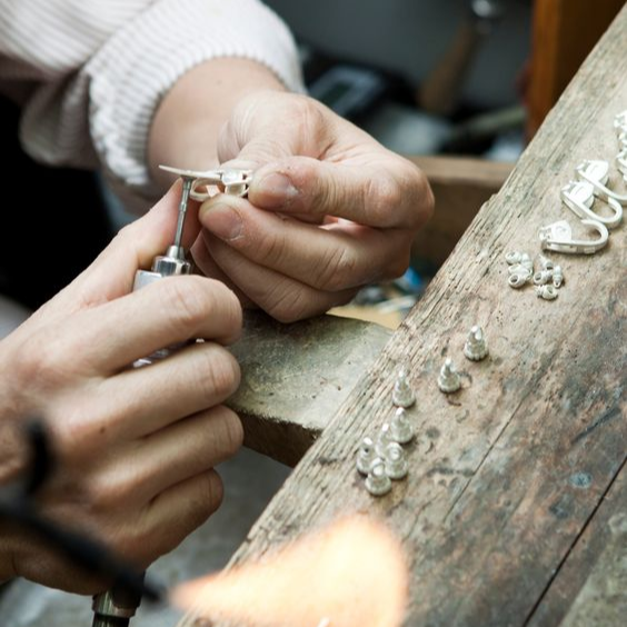 Bench jeweller, polishing ring, with precise craftsmanship.