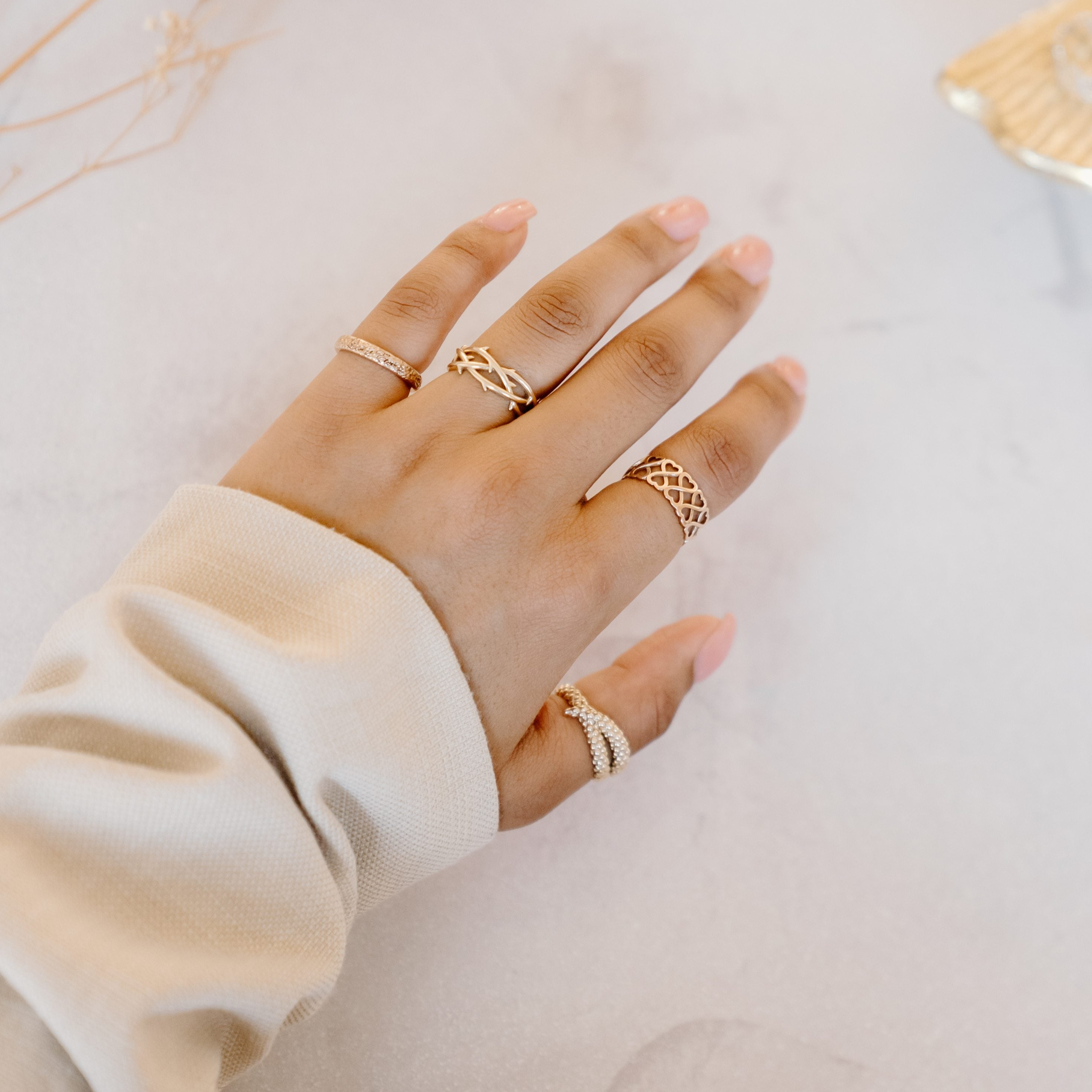 Gold rings that tell a story modelled on one hand.