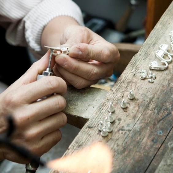 Bench jeweller, polishing ring, with precise craftsmanship. 