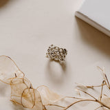 Meaningful ring sitting around white flowers.