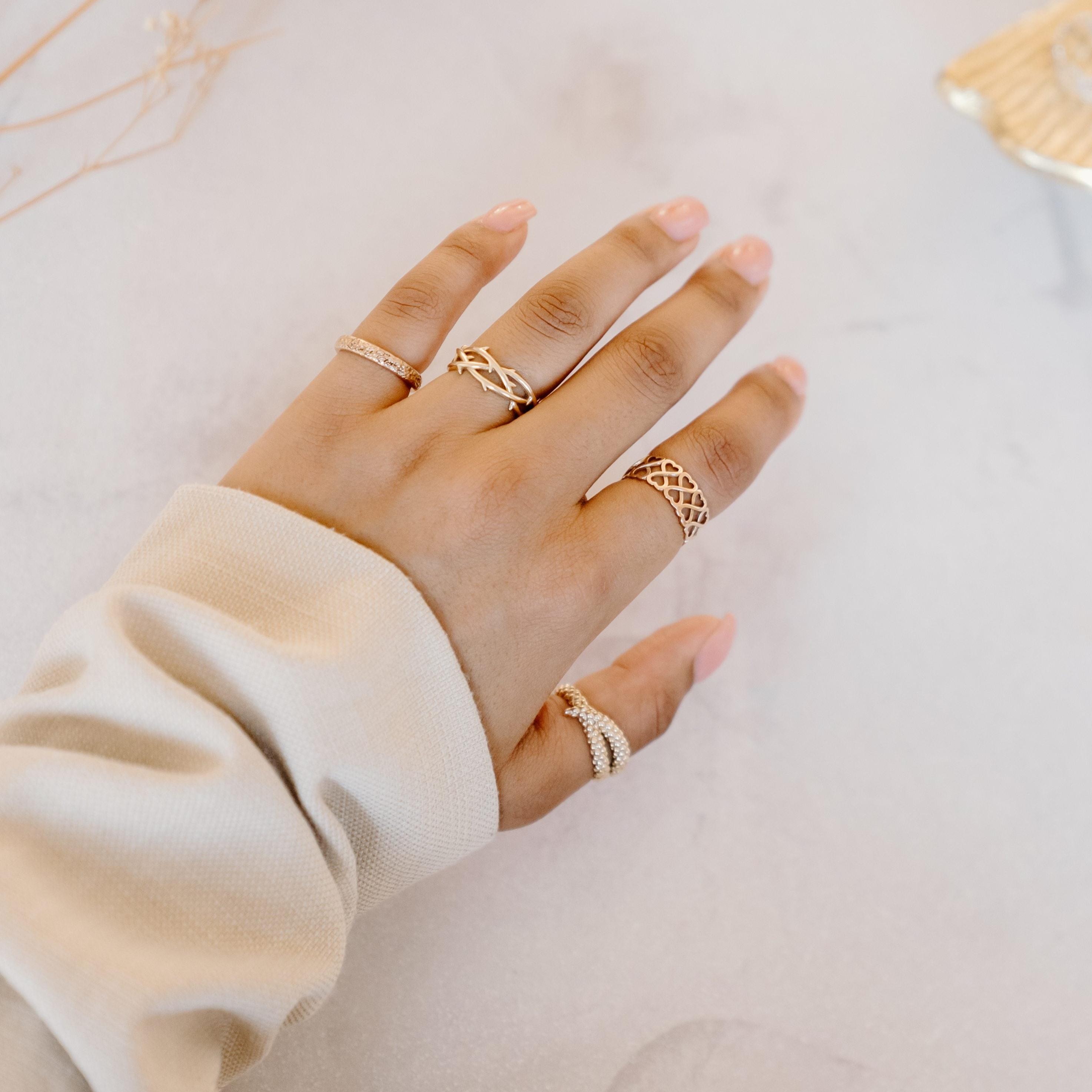 Gold rings that tell a story modelled on one hand. 