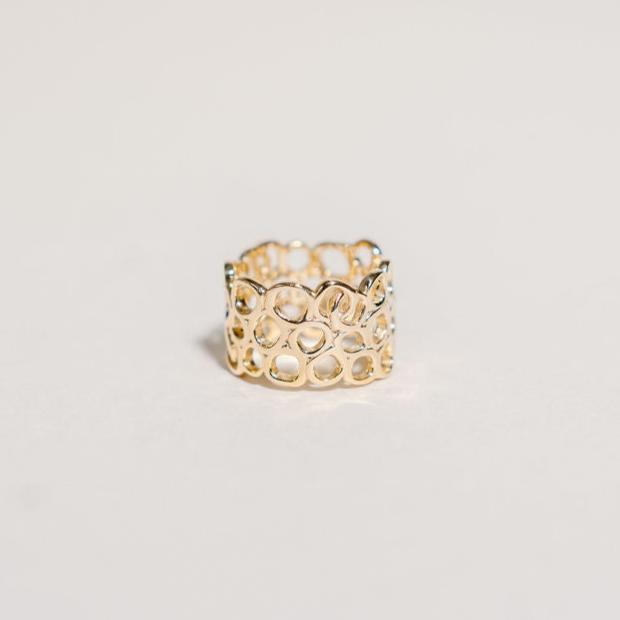 Parva Gold ring on white background.