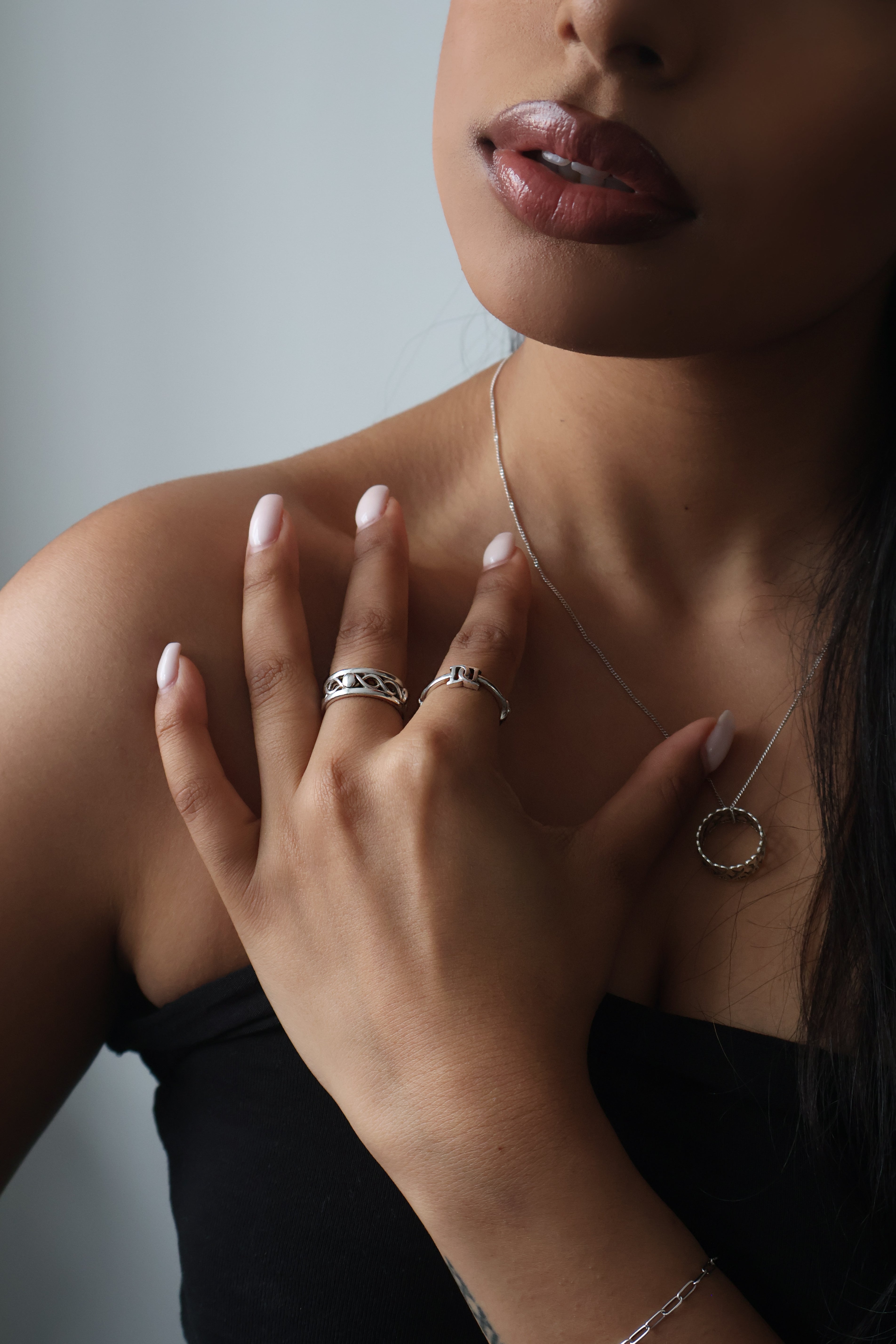 Soul ties rings resting on girls shoulder.